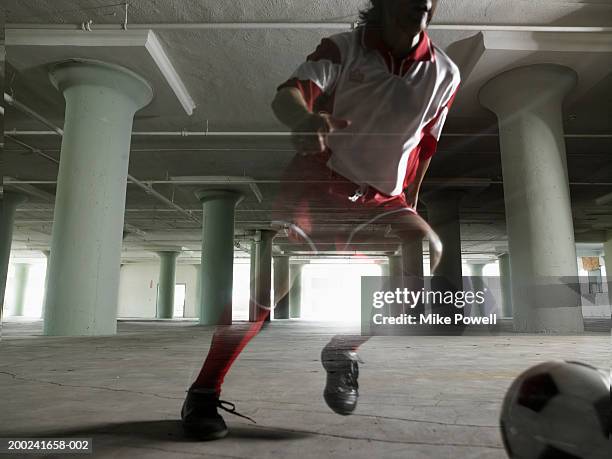 man playing soccer in empty warehouse - double exposure running stock pictures, royalty-free photos & images