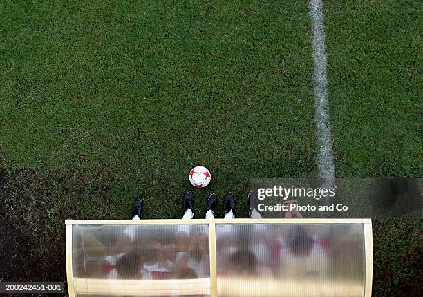 four male football players sitting on bench, overhead view - auswechselspieler stock-fotos und bilder