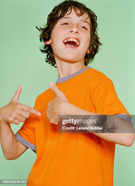 boy (10-12) looking away, smiling - boy 10 11 stock pictures, royalty-free photos & images
