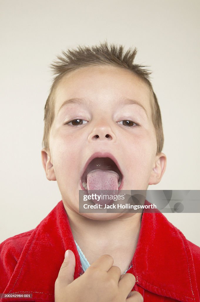 Portrait of a boy sticking out his tongue