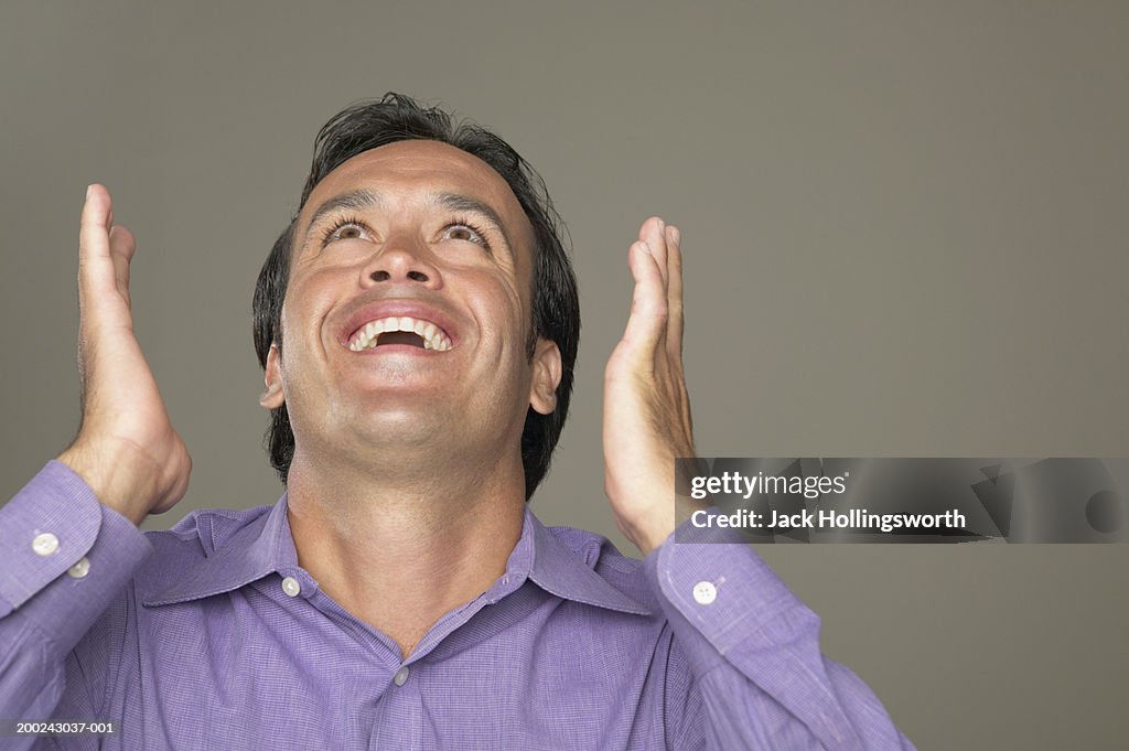 Young man looking up and smiling