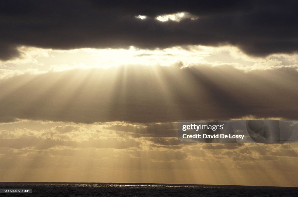 Norway, sunbeams shining through stormy clouds, golden