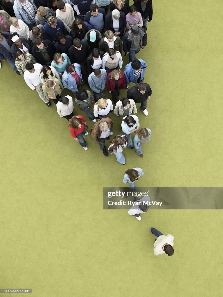 Man walking, followed by gradually increasing crowd, overhead view