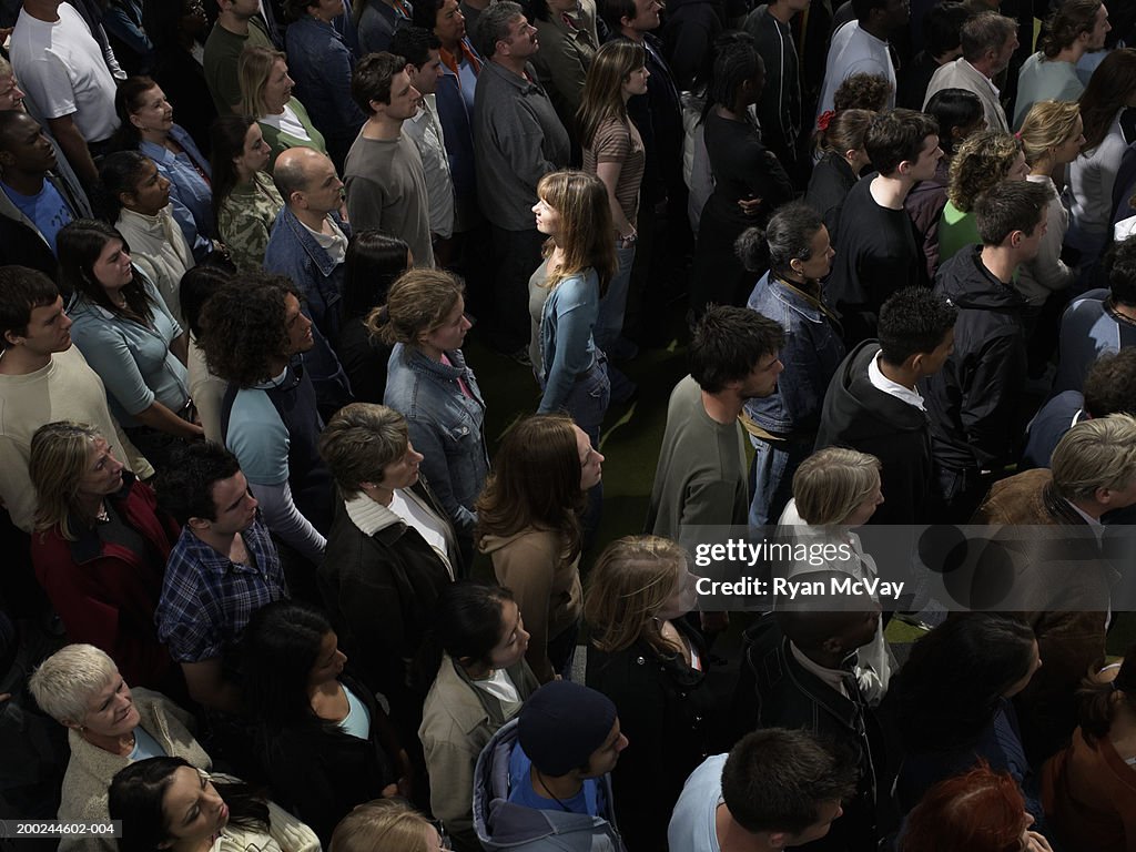 Woman facing opposite direction to crowd, side view, elevated view