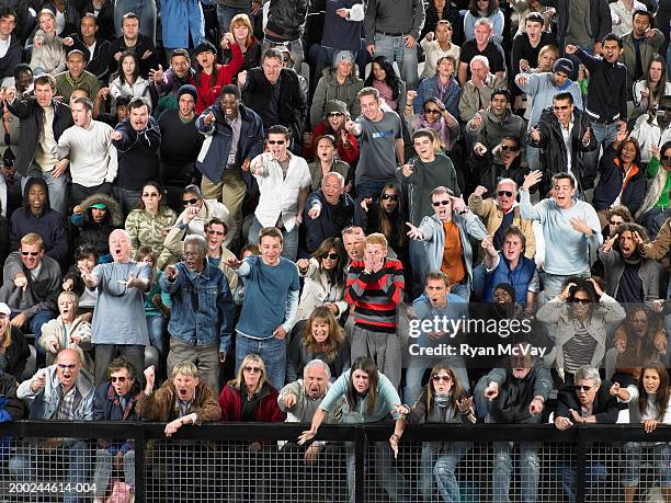 stadium crowd pointing and shouting in same direction, full frame - stadium seats stock pictures, royalty-free photos & images