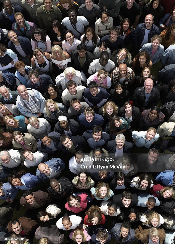 Crowd of people looking upwards, smiling, overhead view