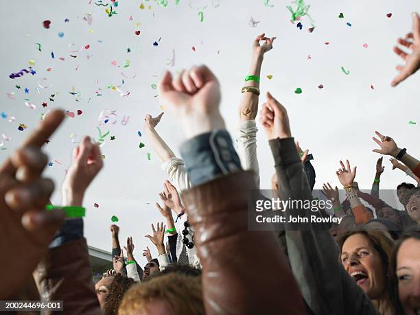 confetti falling over cheering stadium crowd, low angle view - cheering stock pictures, royalty-free photos & images
