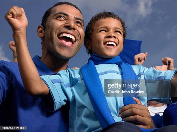 father and son (5-7) in stadium crowd, cheering, close-up - fan scarf bildbanksfoton och bilder