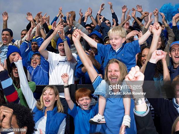 stadium crowd cheering, boy (4-6) sitting on father's shoulders - spectator parent stock pictures, royalty-free photos & images