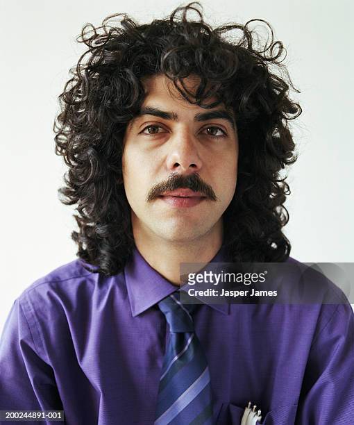 young businessman with curly hair and moustache, portrait, close-up - moustache foto e immagini stock