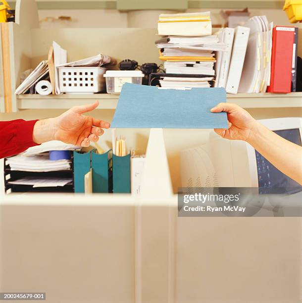 Handing Over File Woman Handing File To Man Over Cubicle Wall Closeup Of Hands High-Res ...