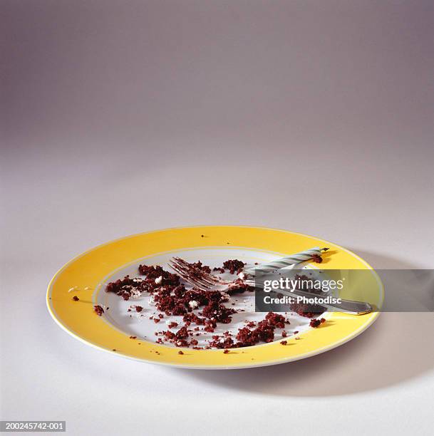 empty plate with crumbs and candle, elevated view - miga fotografías e imágenes de stock