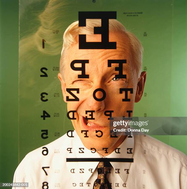 man having eye test closing one eye - eye chart stock pictures, royalty-free photos & images