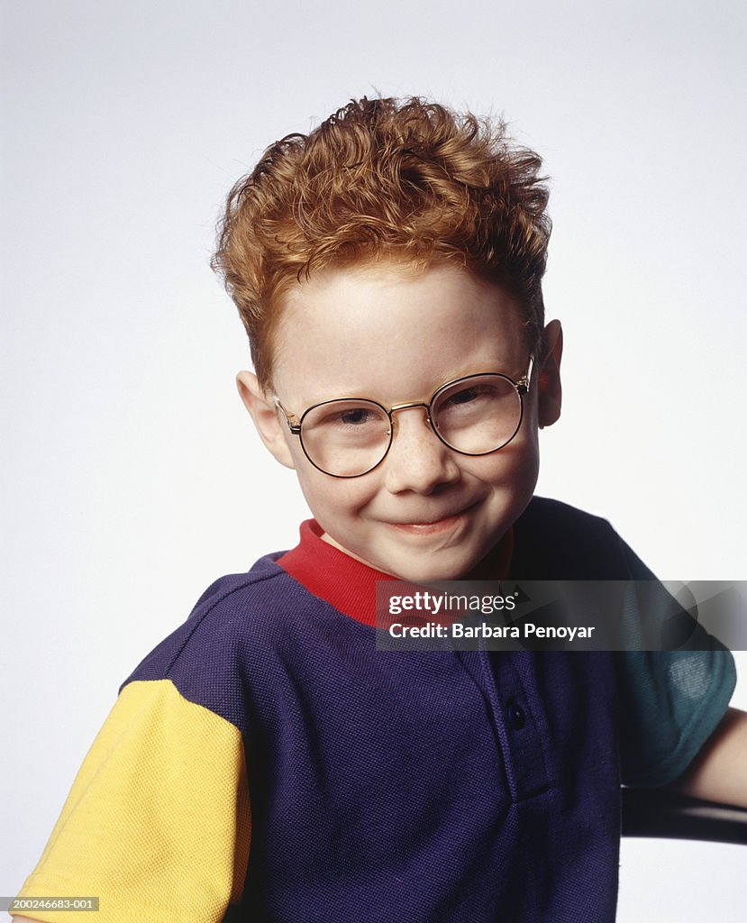 Boy (4-5) wearing spectacles, posing in studio, (Portrait)