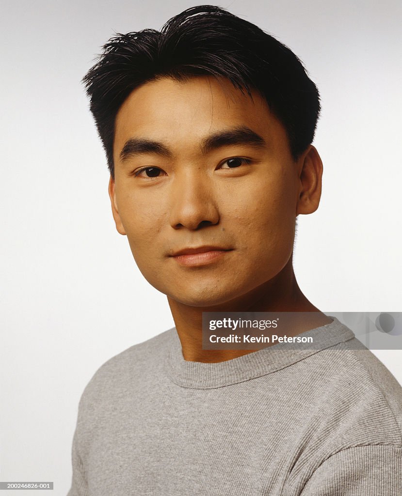 Young man with dark hair, posing in studio, (Portrait)