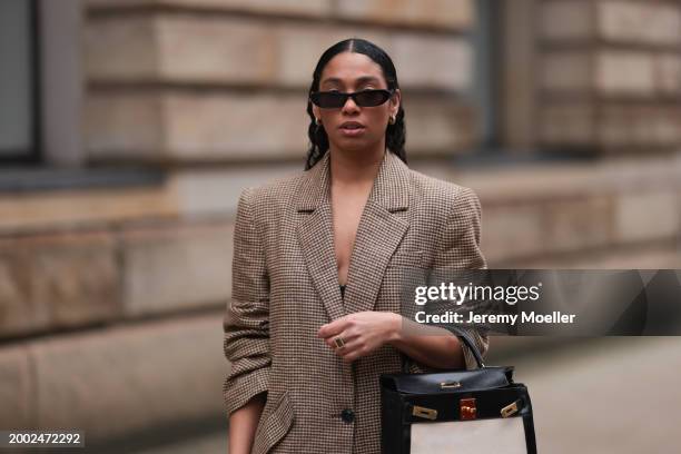 Cherifa Akili seen wearing YSL black sunglasses, gold earrings, Yes My Love beige / black houndstooth pattern elegant blazer jacket, Hermès Kelly...