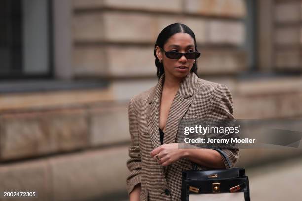 Cherifa Akili seen wearing YSL black sunglasses, gold earrings, Yes My Love beige / black houndstooth pattern elegant blazer jacket, Hermès Kelly...