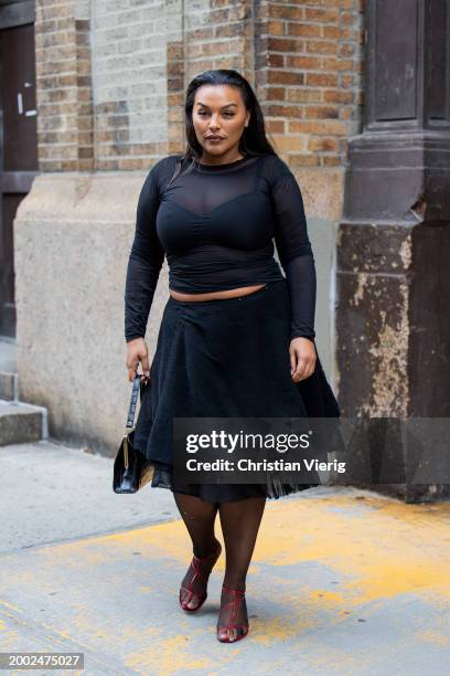 Paloma Elsesser wears black top, skirt outside Proenza Schouler on February 10, 2024 in New York City.