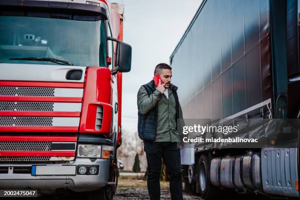 professional truck driver in front on his truck - advanced driver assistance systems stock pictures, royalty-free photos & images