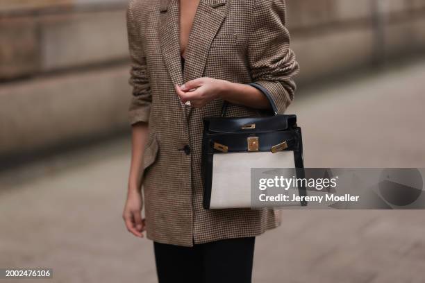 Cherifa Akili seen wearing Yes My Love beige / black houndstooth pattern elegant blazer jacket, Khaite black denim straight leg jeans pants, Hermès...