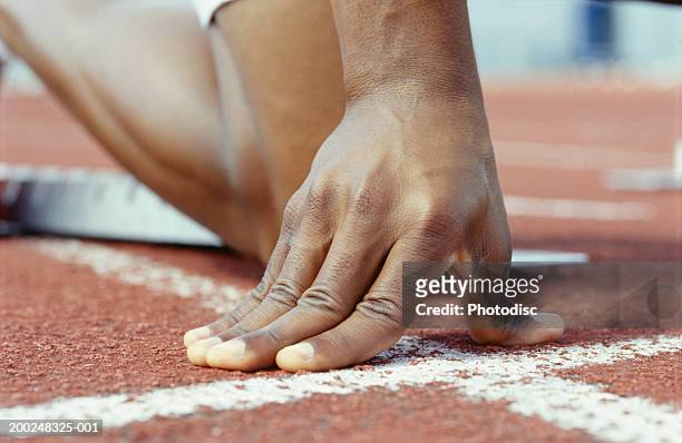 person kneeling with hands on starting line, close-up of hand - starting block stock pictures, royalty-free photos & images