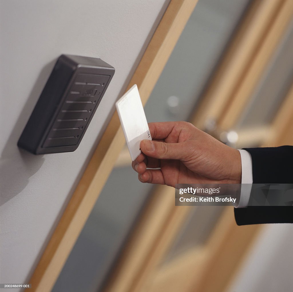 Man inserting card key into card reader, Close-up of hand, (Close-up)