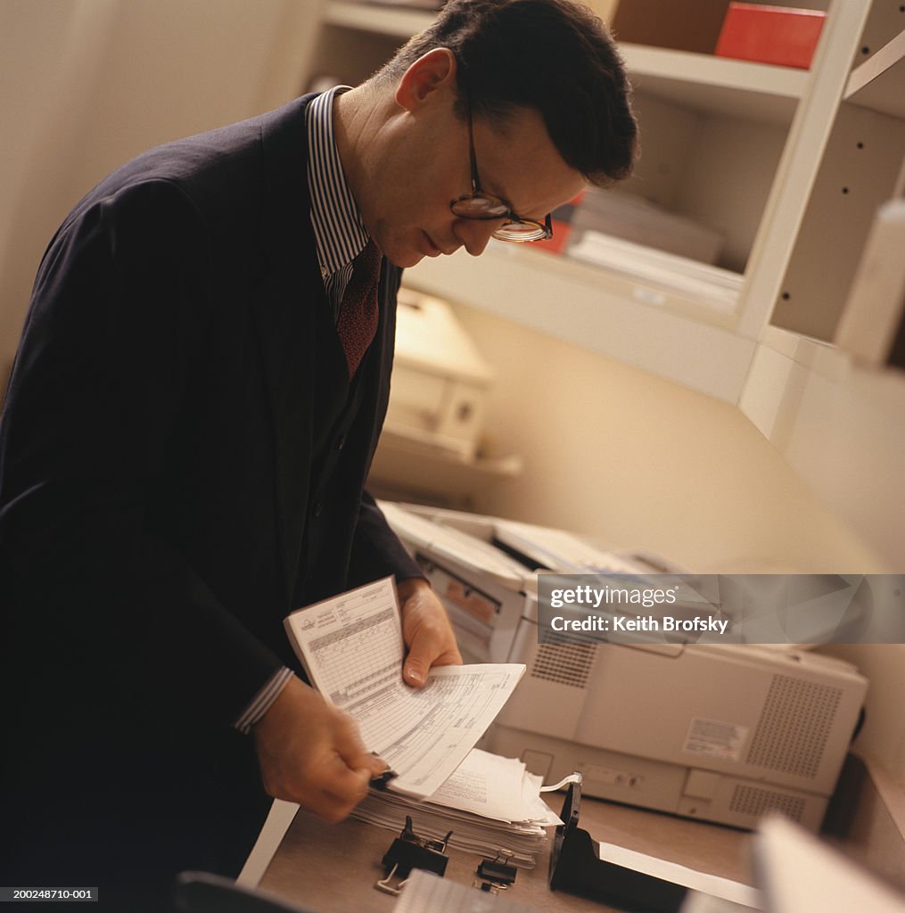 Businessman using fax machine