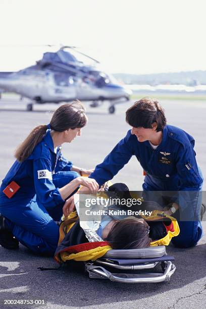 nurses with patient on stretcher brought from helicopter - elicottero-ambulanza foto e immagini stock