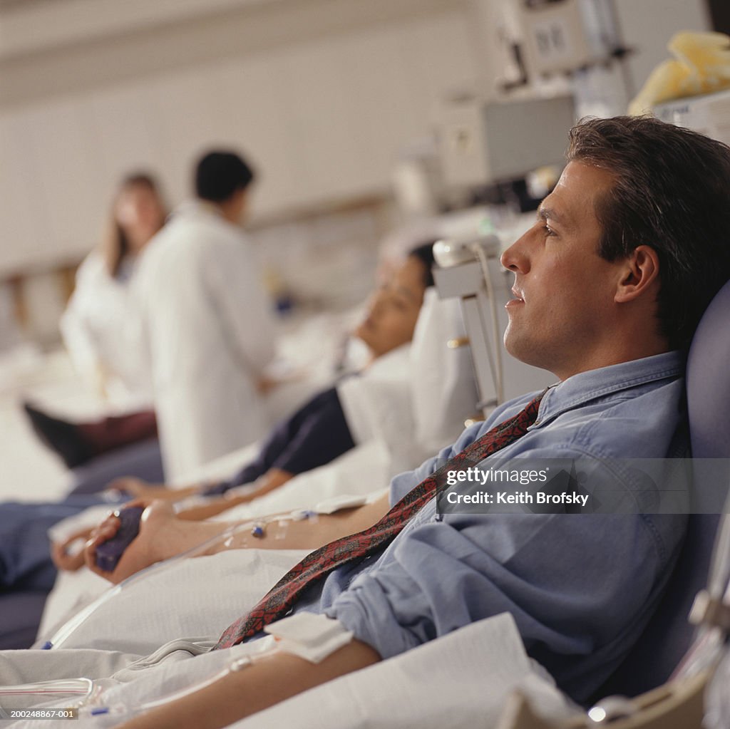Man giving blood in hospital