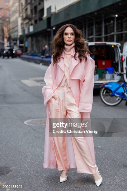 Coco Rocha wears pink pants, coat, turtleneck outside Lapointe on February 10, 2024 in New York City.