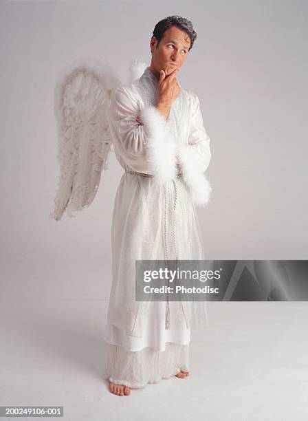male in angel outfit, pondering - man angel wings stock pictures, royalty-free photos & images
