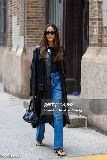 Tamara Kalinic wears black coat, denim jeans, shirt, sandals, bag outside Proenza Schouler on February 10, 2024 in New York City.