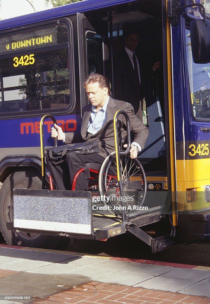 Man in wheelchair exiting bus