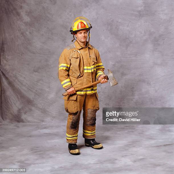 fire-fighter holding axe, (portrait) - fireman axe stock pictures, royalty-free photos & images