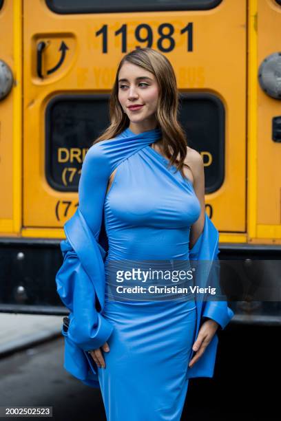 Guest wears blue wrapped dress outside Lapointe on February 10, 2024 in New York City.