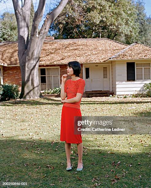 young woman standing outside house - stoneplus15 ストックフォトと画像