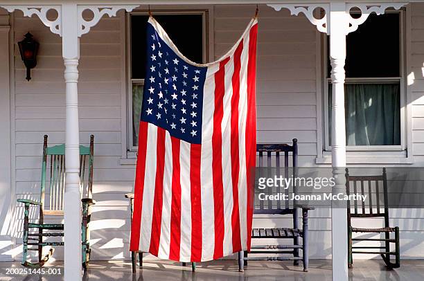 usa flag hanging on porch, july - hanging flag stock pictures, royalty-free photos & images