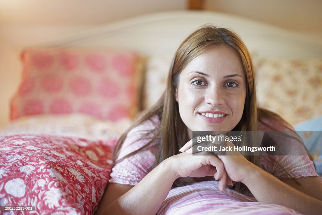 Portrait of a young woman resting her face on her hand