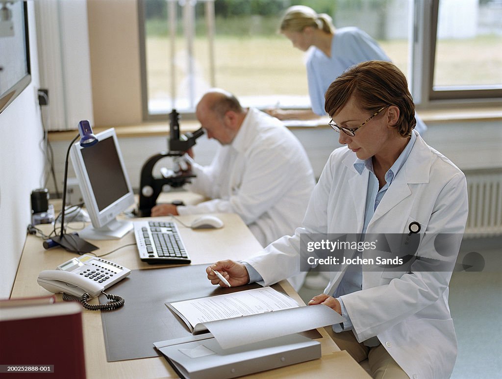 Female doctor sitting in office, portrait