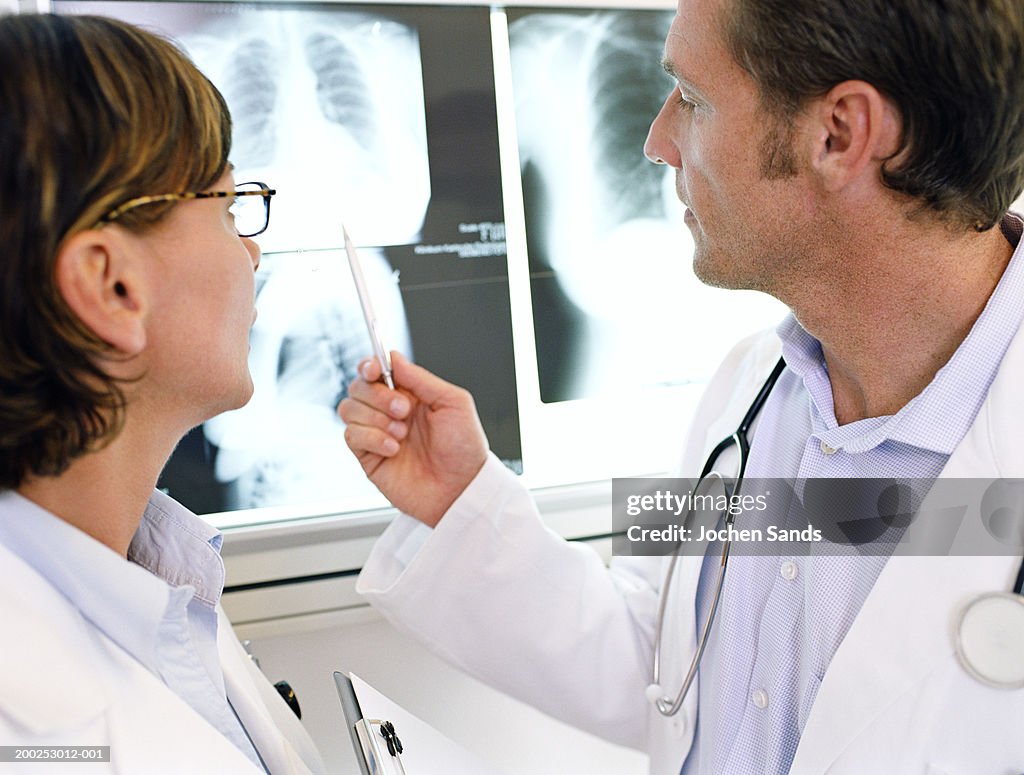 Male and female doctors looking at x-ray, close-up