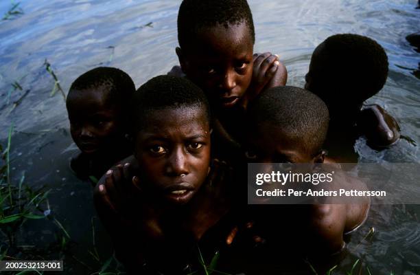 Children swim in a rural river on February 08, 2003 close to Nkomano Bridge, in Ntyazo, a rural area outside Butare, Rwanda. About one hundred people...