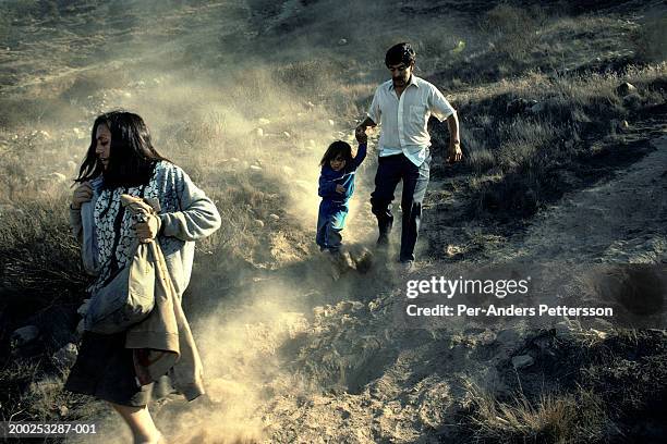 mexican family runs over the border illegally into the united states in san diego, california - climate refugees stock-fotos und bilder