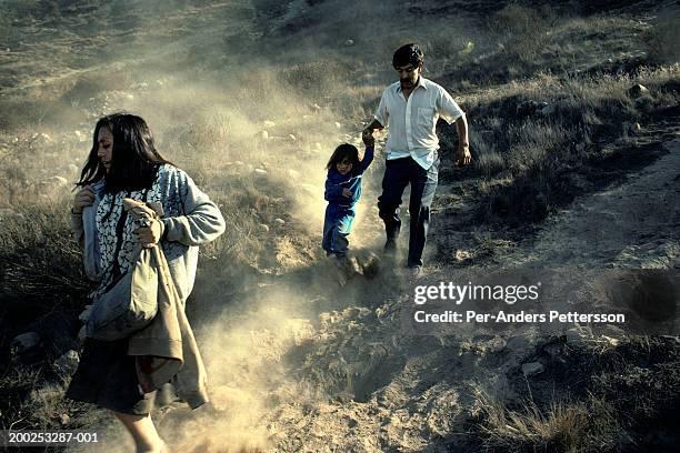 mexican family runs over the border illegally into the united states in san diego, california - displaced people stock pictures, royalty-free photos & images