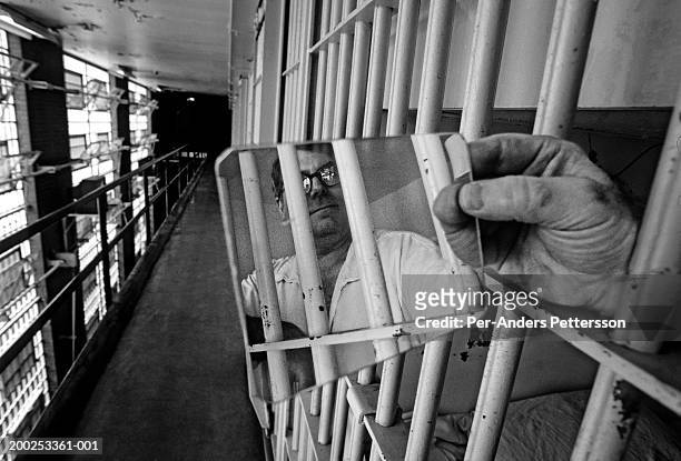 An unidentified prisoner on Death Row looks in a mirror in the corridor on April 22, 1997 at Ellis Unit in Huntsville, Texas USA. Texas has about 450...