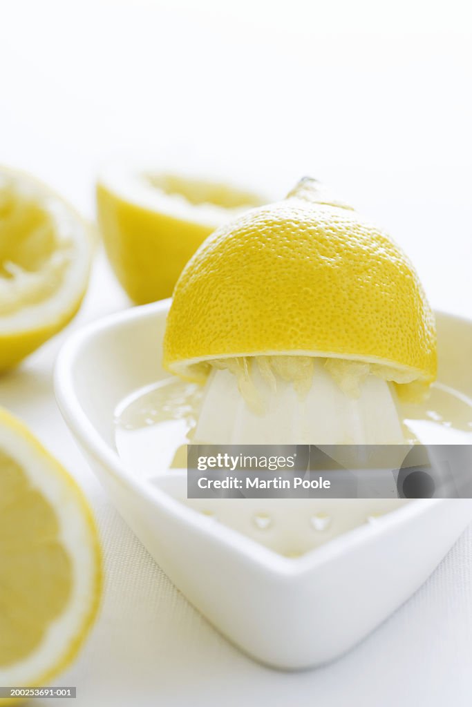 Lemon half and juice squeezer, close-up