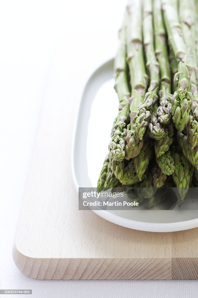 Bunch of asparagus on plate, close-up