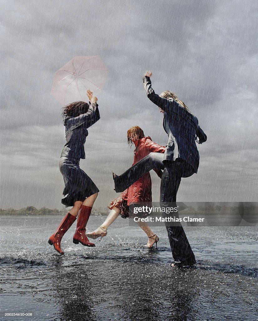 Three women having fun in rain