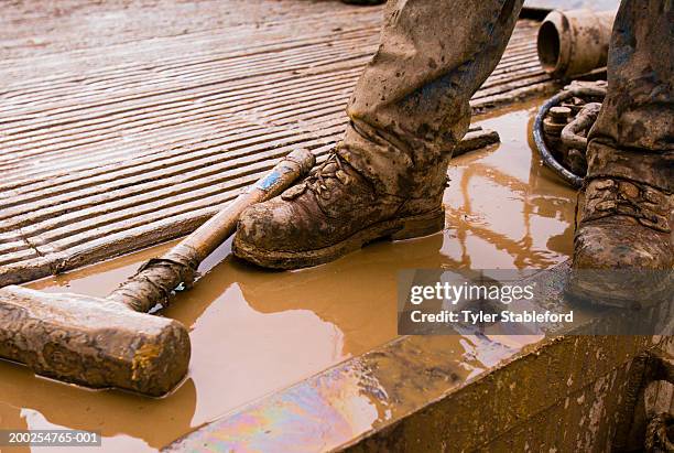 workman standing on oil drilling platform, low section - work boot stock pictures, royalty-free photos & images