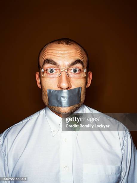man with tape over mouth, portrait - hostage stock pictures, royalty-free photos & images