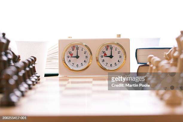 chess board and timer set up on table, close-up (focus on timer) - chess timer stock pictures, royalty-free photos & images